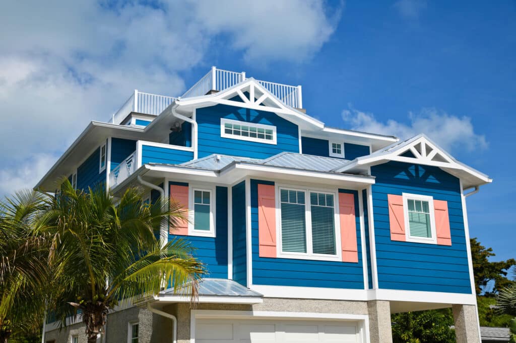 luxurious costal house with blue vinyl siding