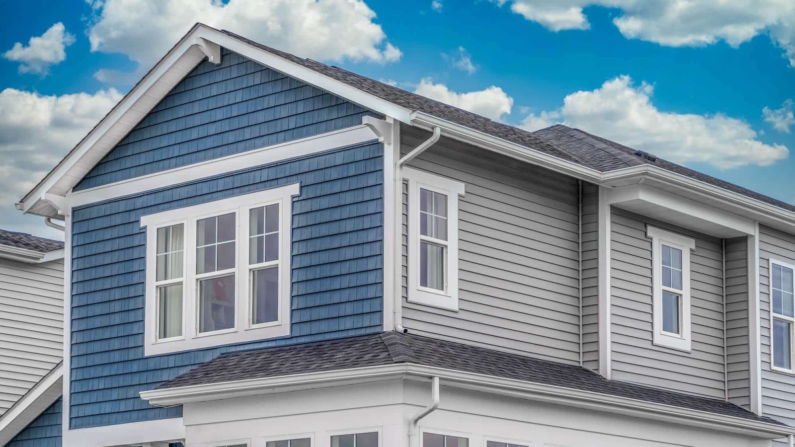 Blue shade and viny siding home with white accent trim - Big Easy Siding